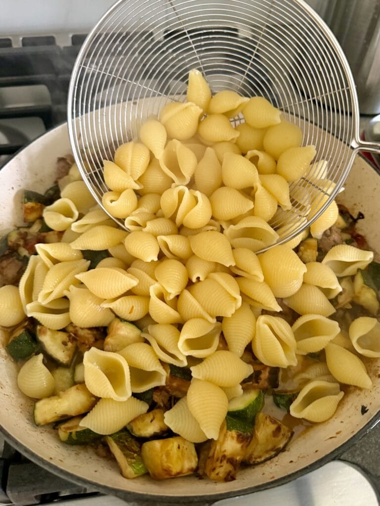 Adding cooked pasta to sauce for Italian Sausage and Zucchini Pasta .