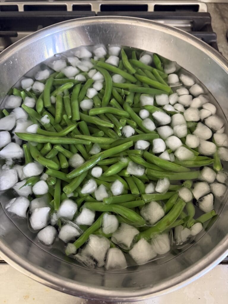 Blanched vegetables in ice water to refresh and stop the cooking process.