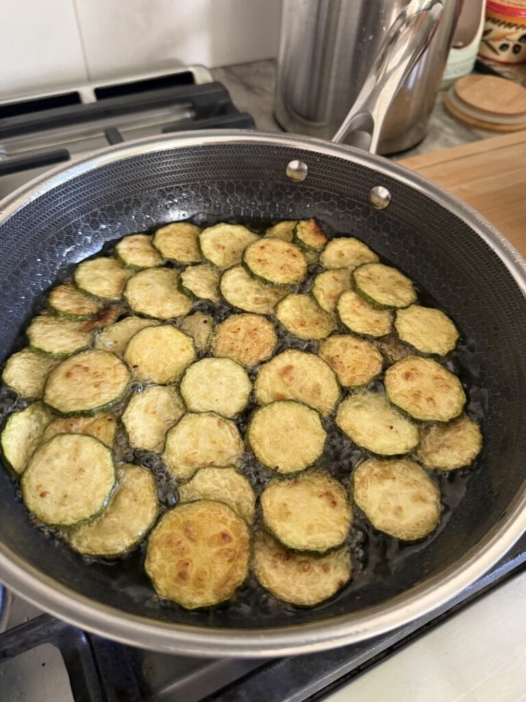 Frying the zucchini in hot oil for Pasta Alla Nerano.