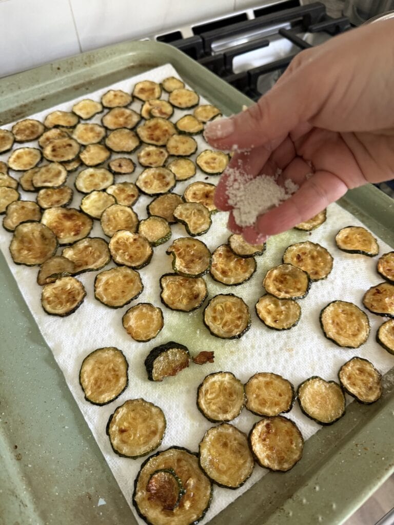 Sprinkling fried veggies with salt.
