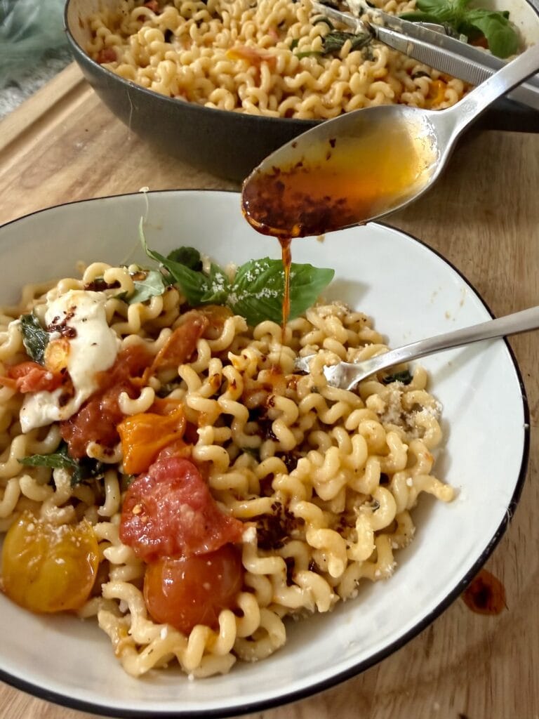 Drizzling Blistered Cherry Tomato Pasta with some Spicy Pepper Oil for a little kick!