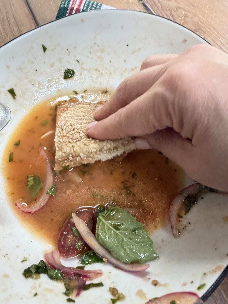 Sopping up the leftover tomato salad juice/dressing with bread.