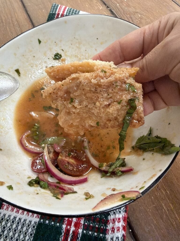 Sopping up the leftover tomato salad juice/dressing with bread.