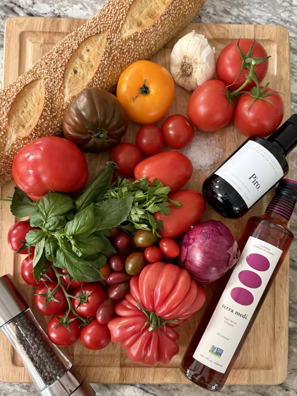 All ingredients for Italian Marinated Tomatoes on cutting board.