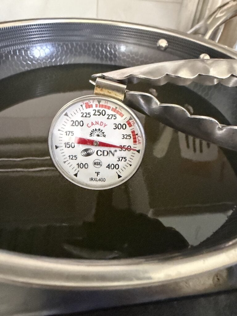 A candy/frying thermometer showing 350 degrees F, the correct oil frying temperature.