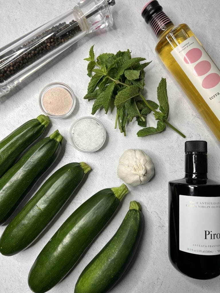 All ingredients for zucchini alla scapece on cutting board.
