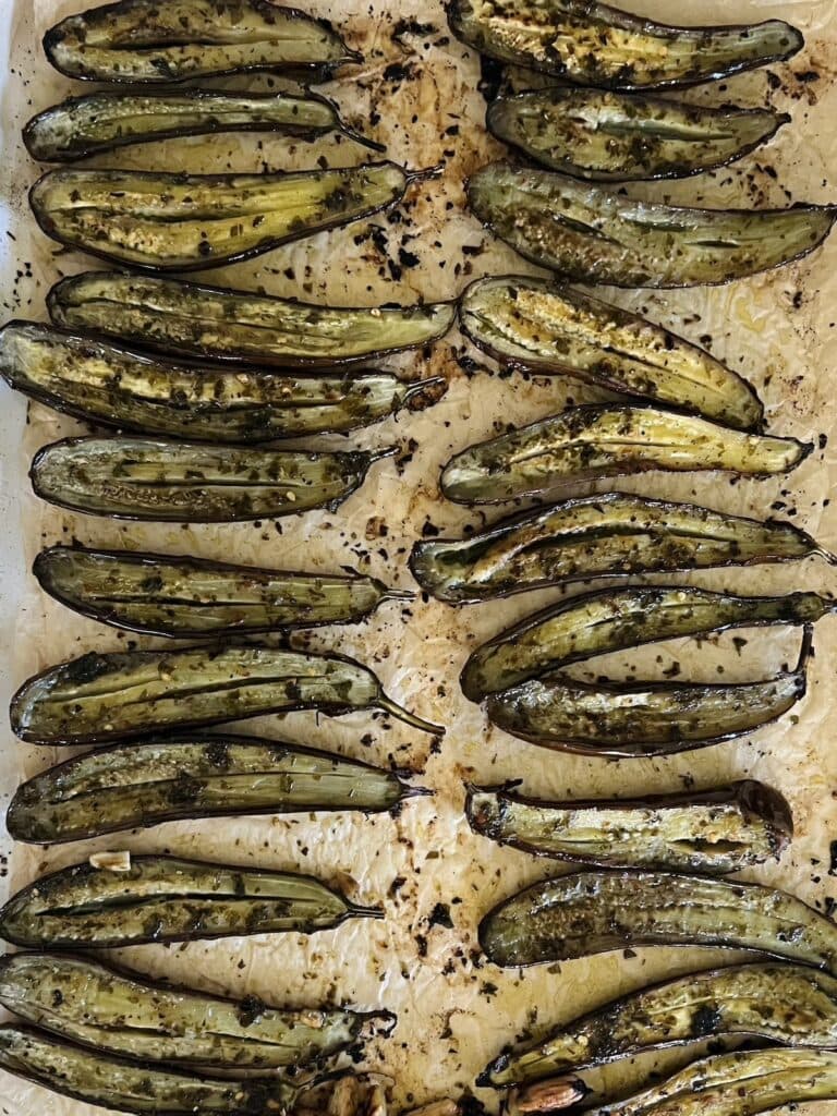 Roasted baby eggplant on sheet pan.