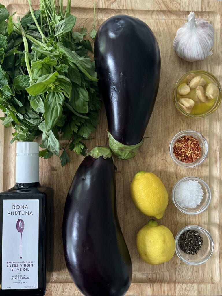 All ingredients for Italian grilled eggplant on cutting board.