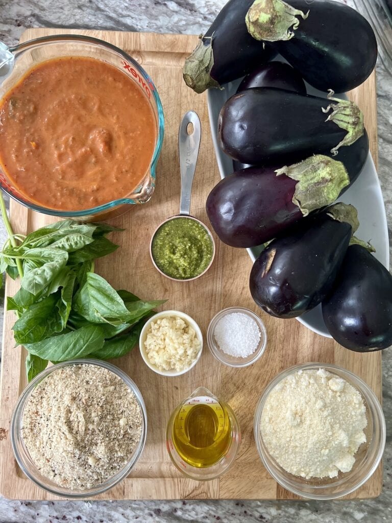 All ingredients for Sicilian stuffed eggplant on cutting board.
