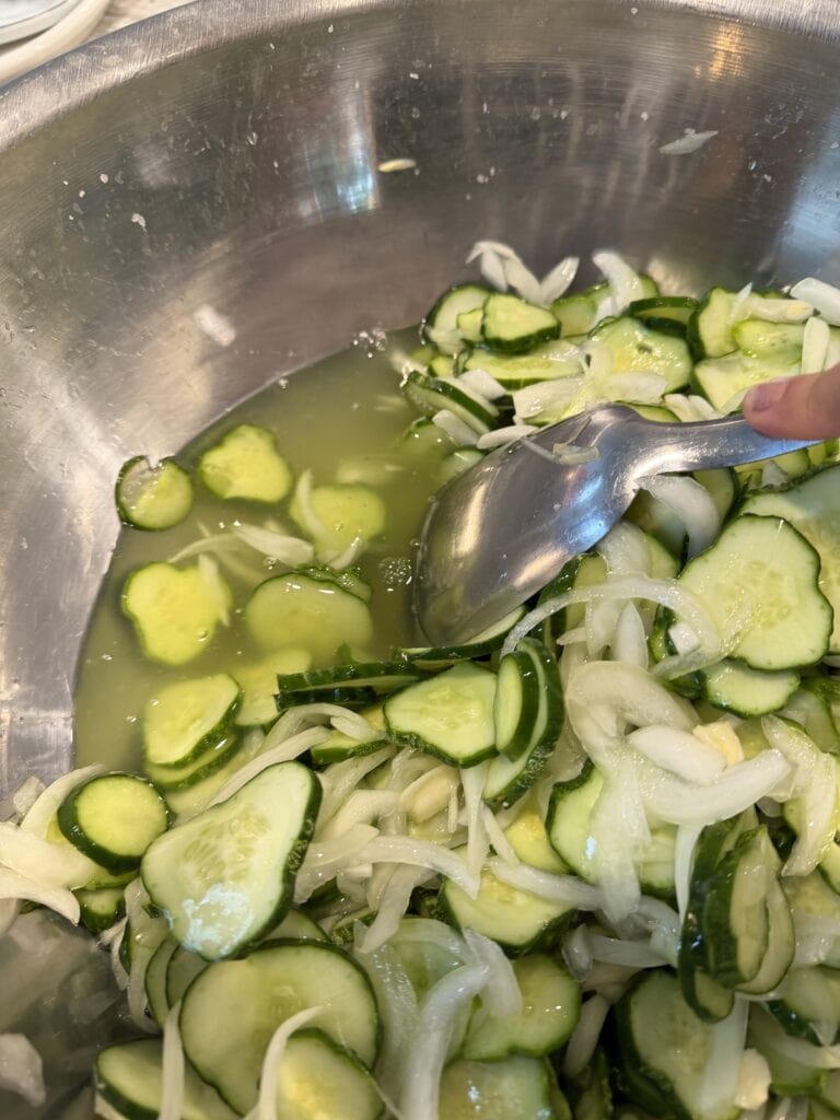 The cucumber onion mixture after it's been sitting for 2 hours, showing the released liquid.