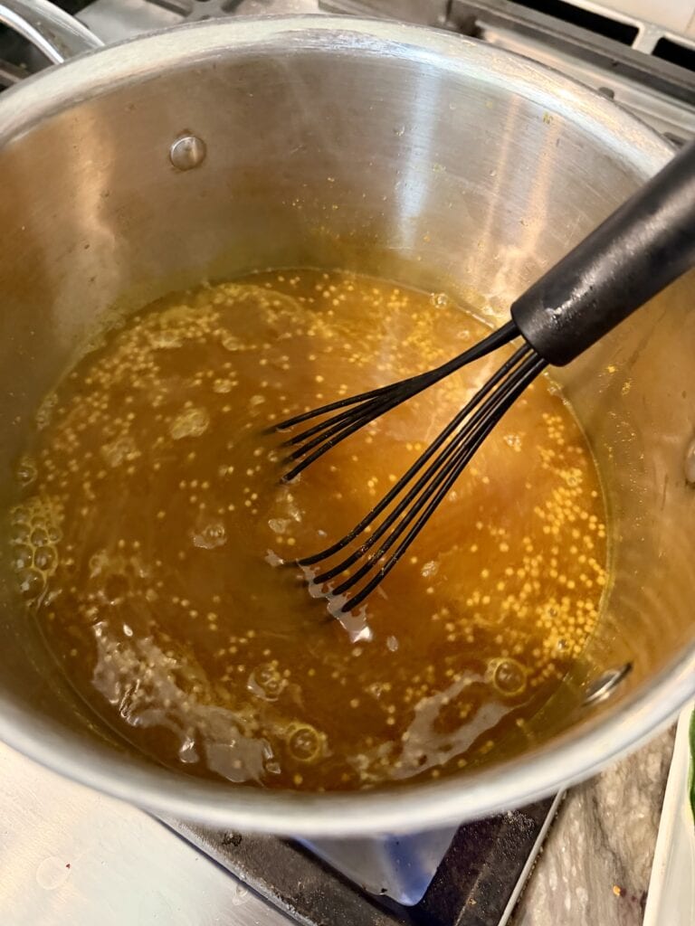 Whisking all brine ingredients for quick no canning pickle recipe in pot.