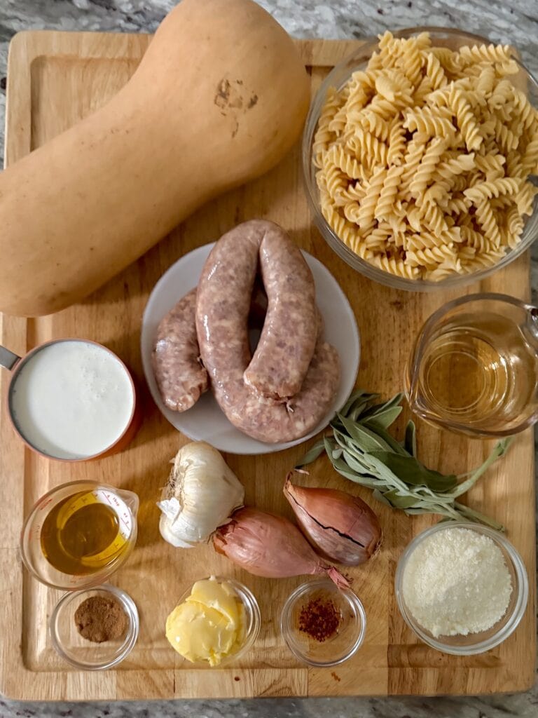 All ingredients for Creamy Butternut Squash Sausage Pasta on cutting board.