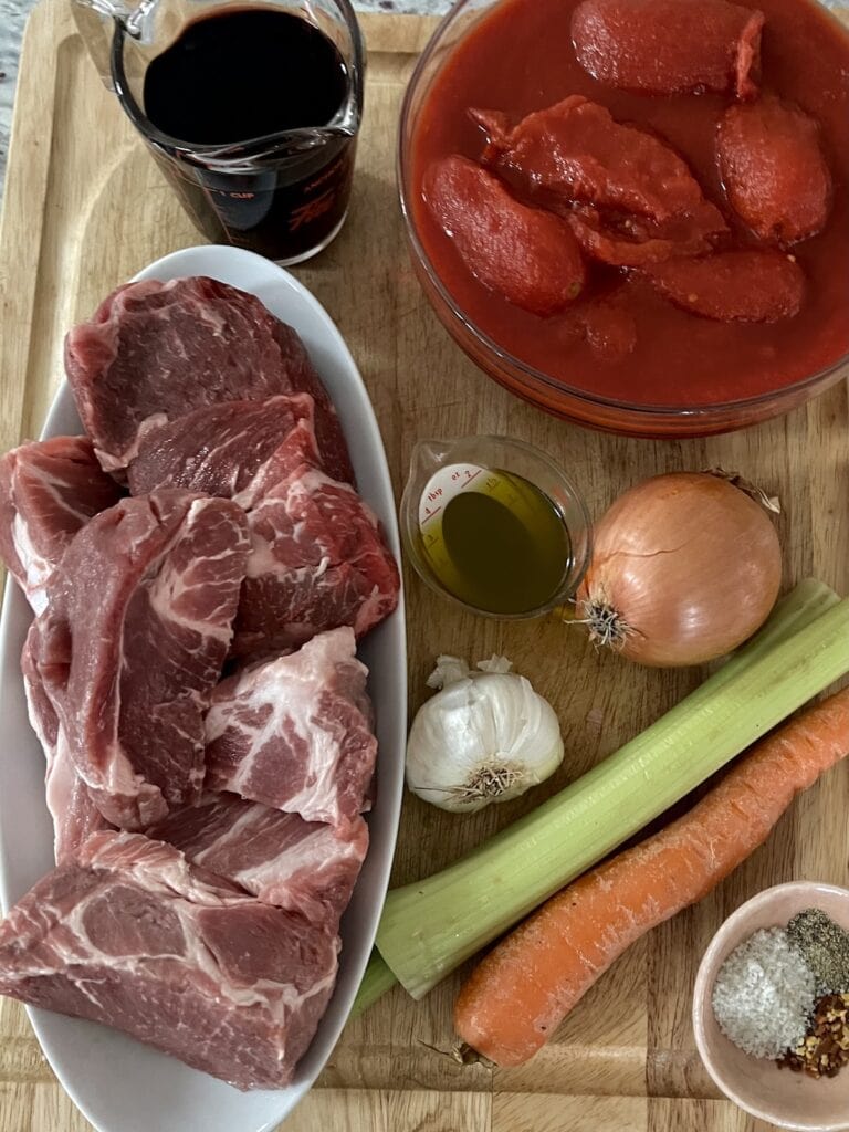 All ingredients for Ragu Napoletano on cutting board.