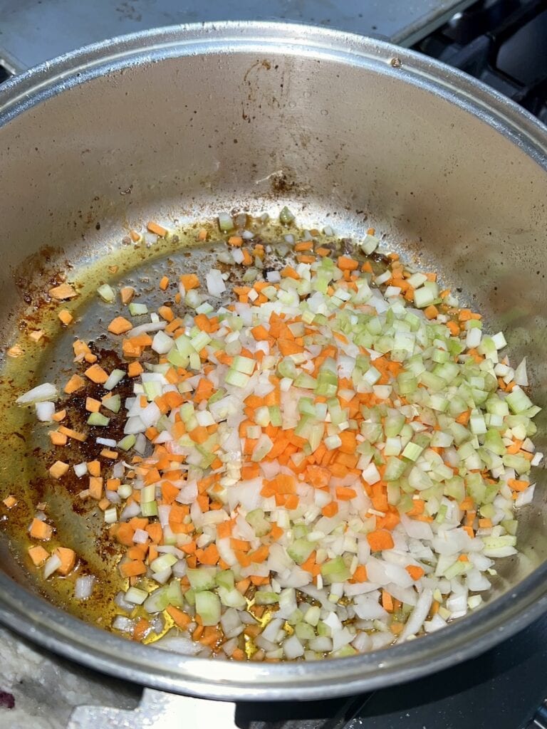 Diced onions, carrots, celery and chopped garlic just added to pot to saute.