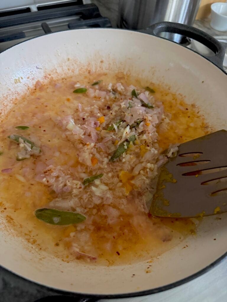 Scraping up the brown bits on bottom of pan with spatula.