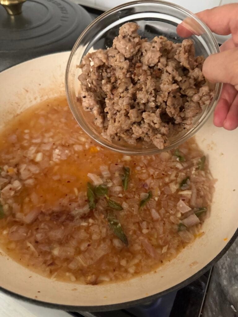 Adding cooked sausage back to pan for butternut squash and sausage pasta.
