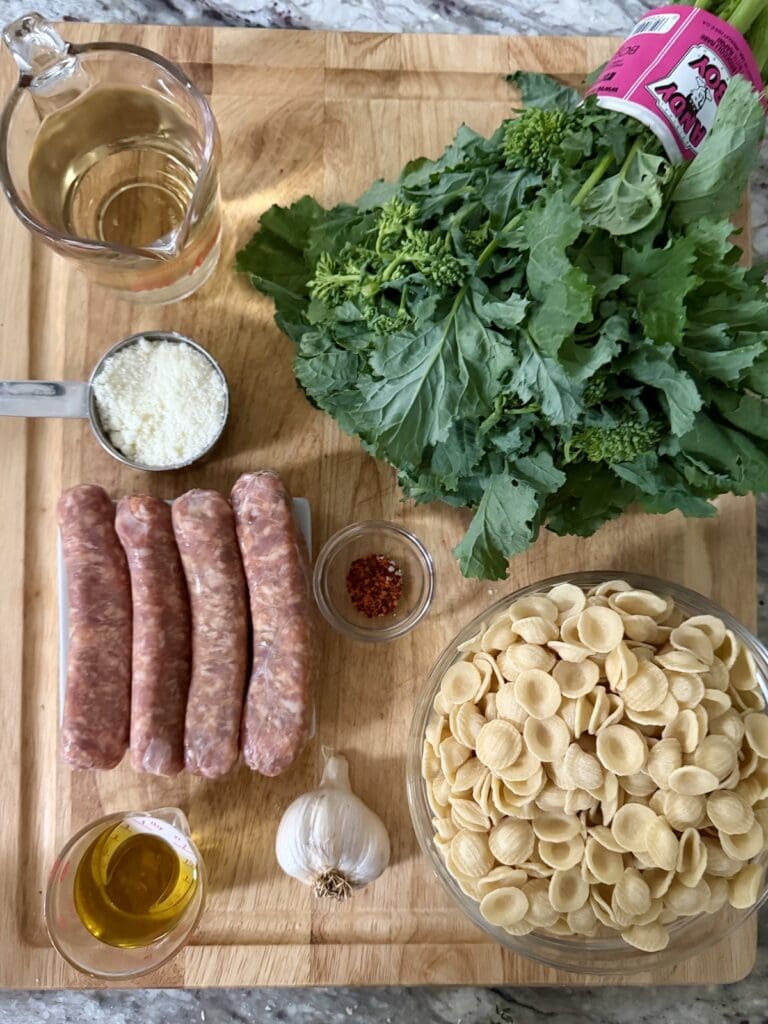 Ingredients for Orecchiette With Broccoli Rabe and Sausage on cutting board.
