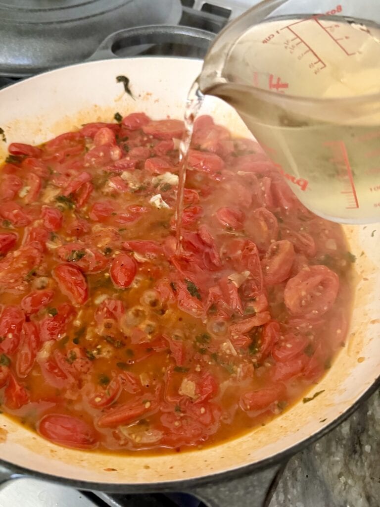 Adding white wine to pan.