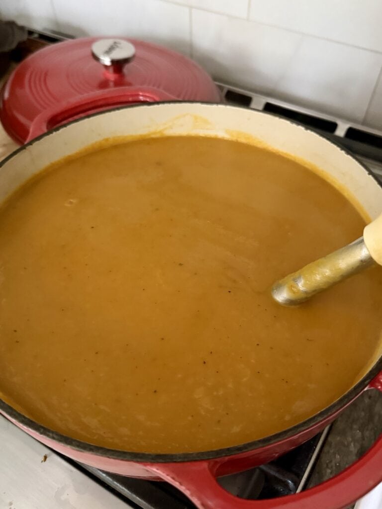Pureeing Italian butternut soup with immersion blender.