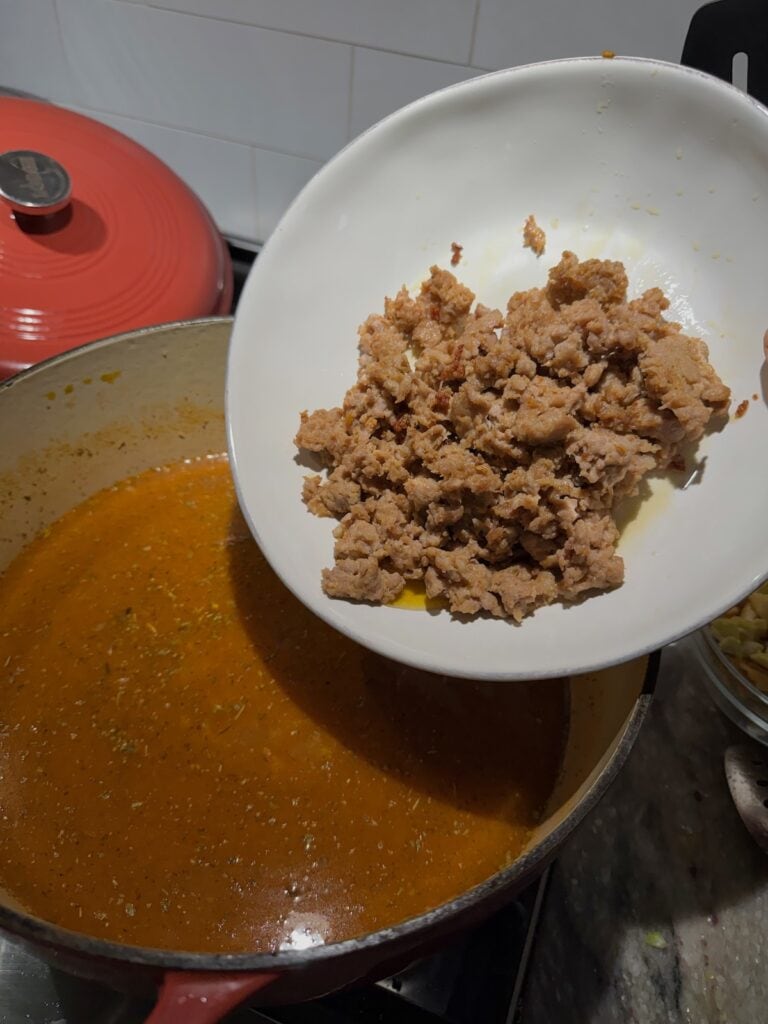 Adding sausage back to broth.