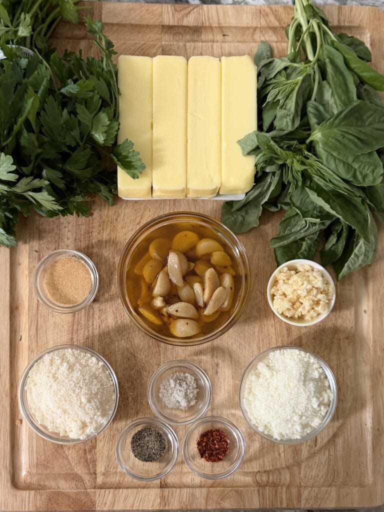 All ingredients for garlic compound butter on cutting board.