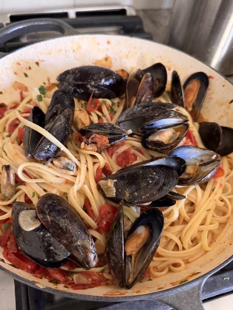 Finished linguine with mussels still in pan.