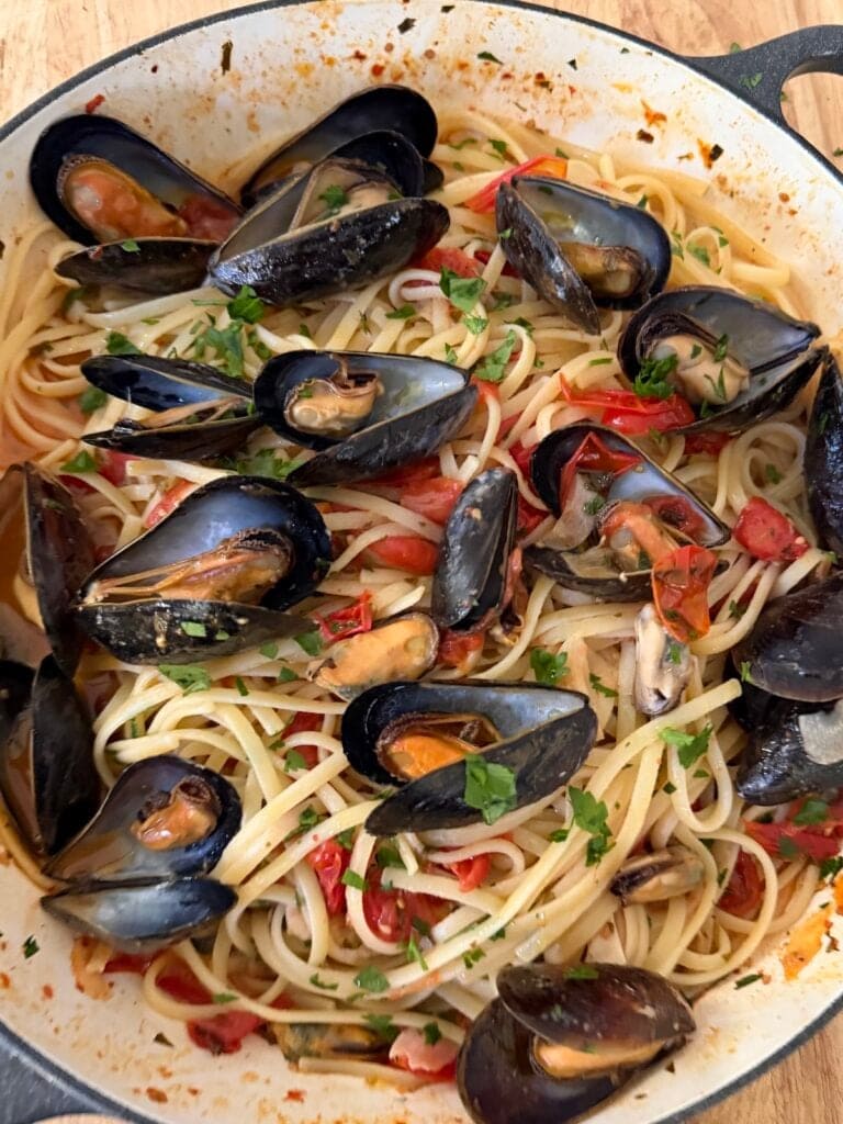 Finished linguine with mussels still in pan.