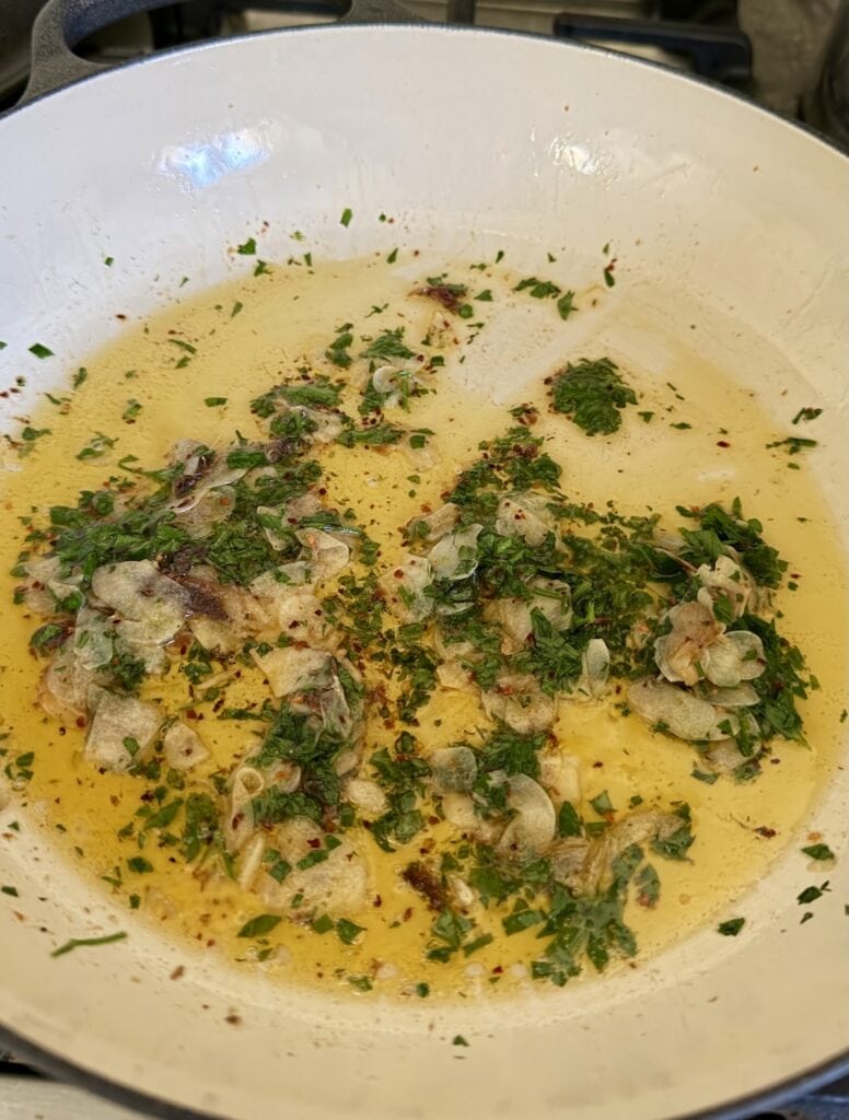Sautéing aromatics in pan with olive oil.