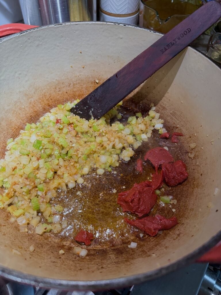 Caramelizing tomato paste in pot.