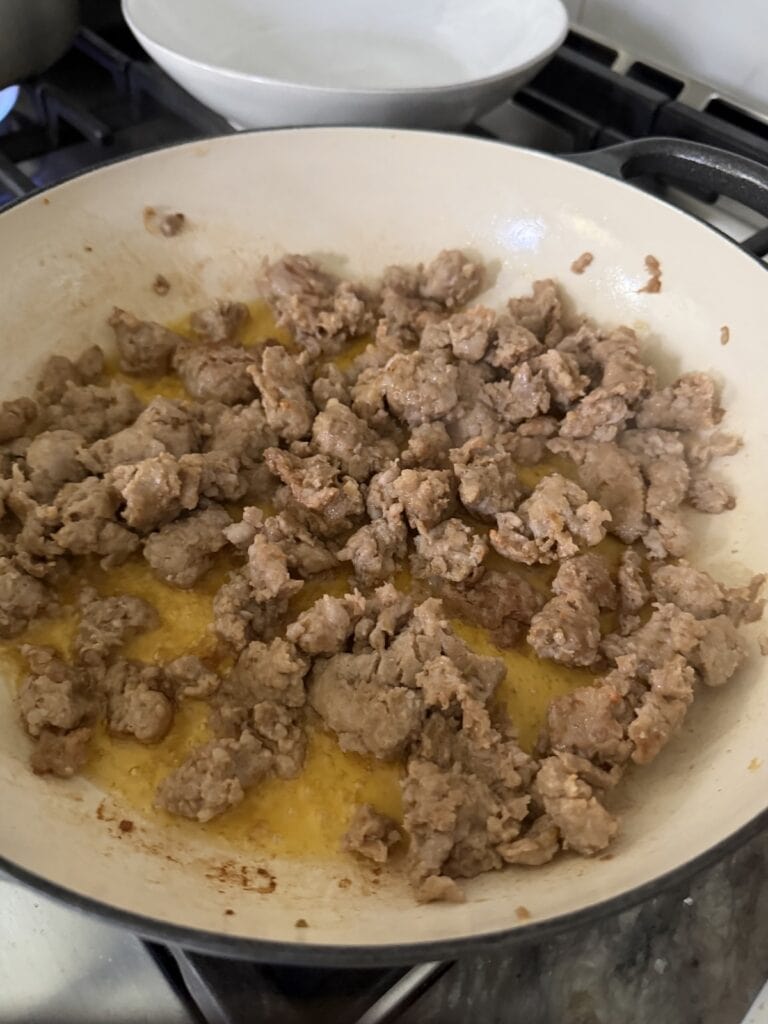 Browned sausage in pan.