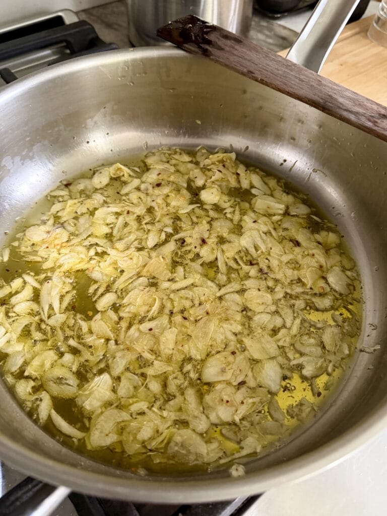 Sautéing garlic in olive oil.